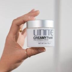 UNITE creamy paste jar next to inch ruler illustrating compact 2 oz size for travel convenience