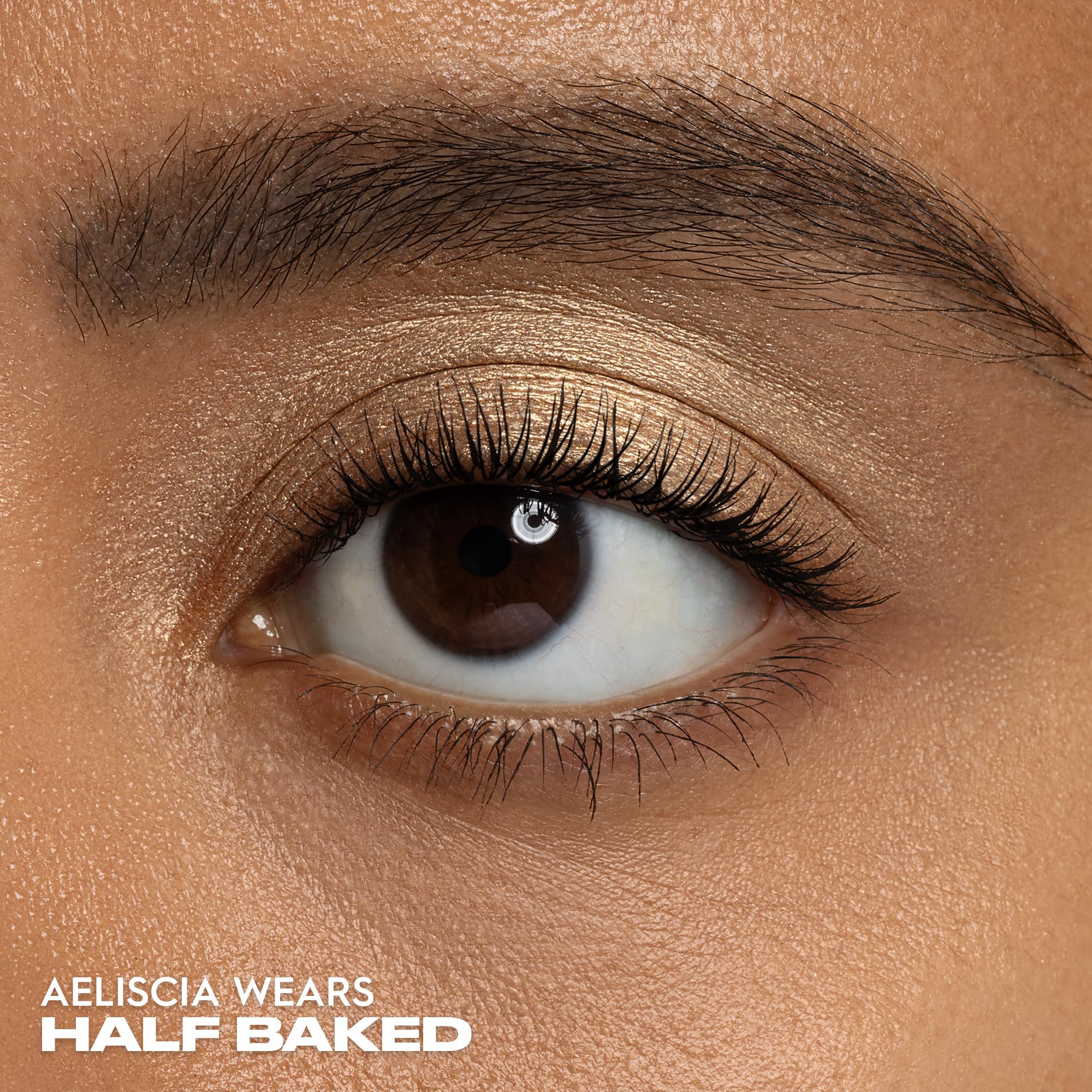 Urban Decay applied on eyelid showing luminous gold highlight and crease-resistant wear benefit