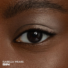 URBAN DECAY Sin swatch on skin demonstrating champagne shimmer payoff and reflective glow benefit