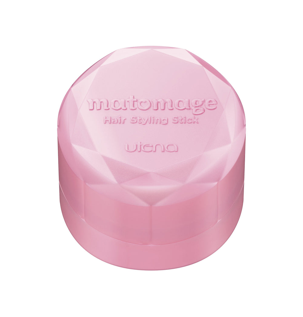 Utena Matomage stick size comparison with hand showing portable travel benefit