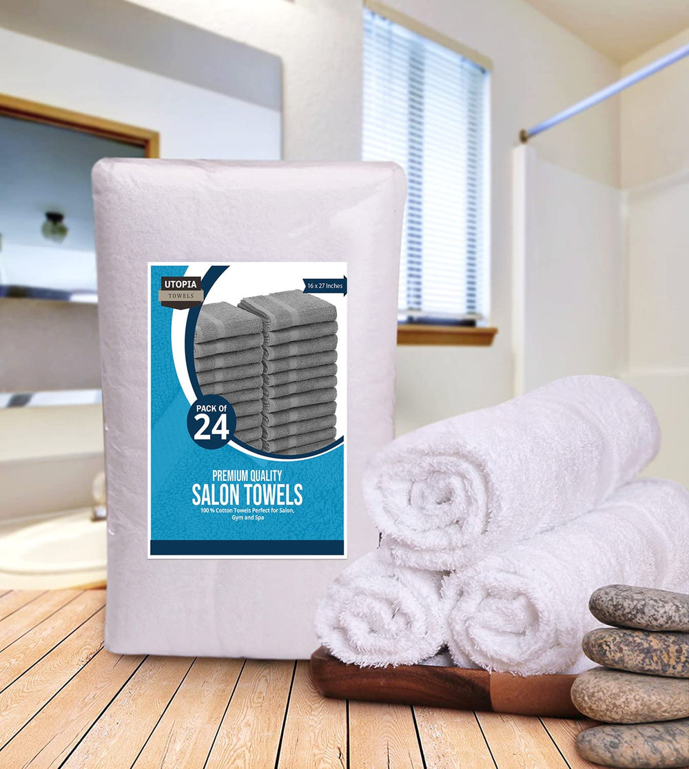 Utopia Towels held by hand to illustrate the 16x27 inch size and scale