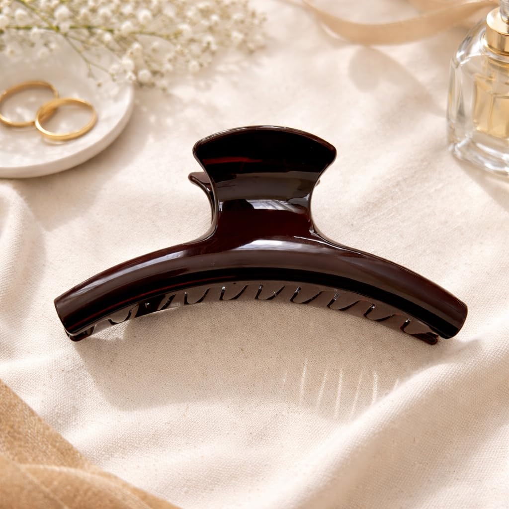 UVANKAUP on a desk with outfit showing polished chocolate clip as versatile accessory