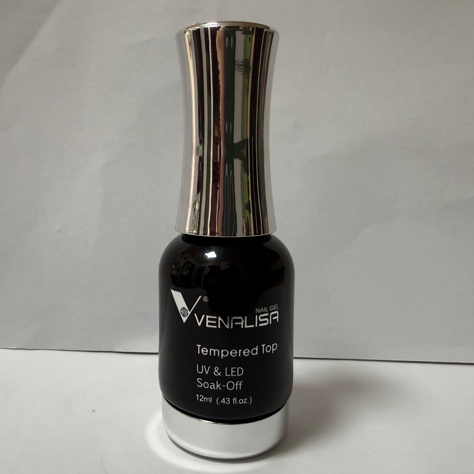 V VENALISA bottle in a desk manicure setup showing convenient home use
