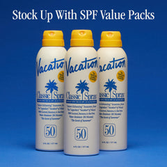 VACATION bottle on beach towel evoking outdoor sun protection