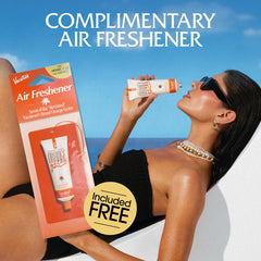VACATION lifestyle shot applying sunscreen on beach for luminous skin