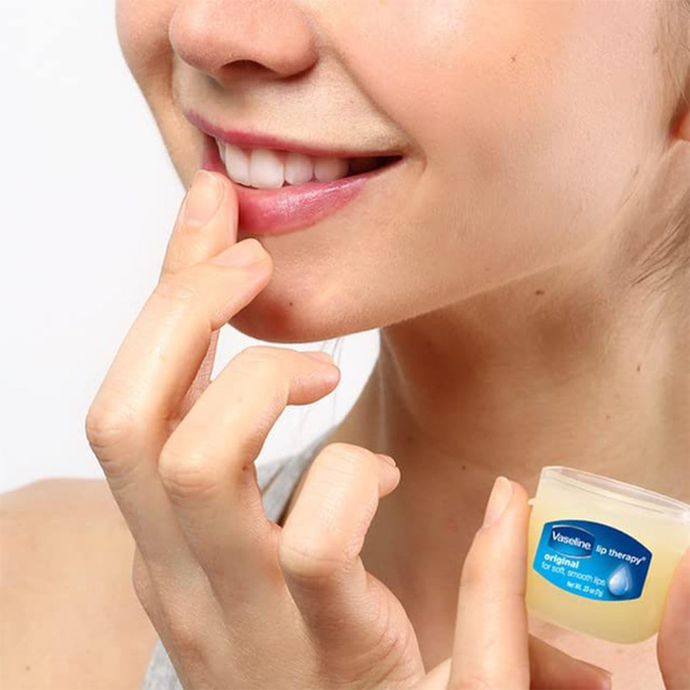 Applying Vaseline to lips for lasting softness and chapped-lip relief