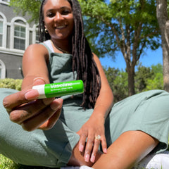 Vaseline stick inside a purse pocket demonstrating travel-ready convenience benefit