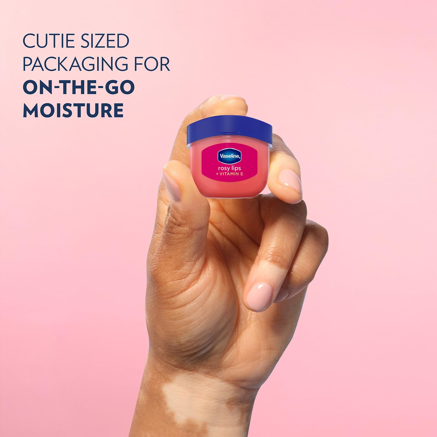 Hand applying Vaseline Rosy Lips on lips for instant smoothing and sheen