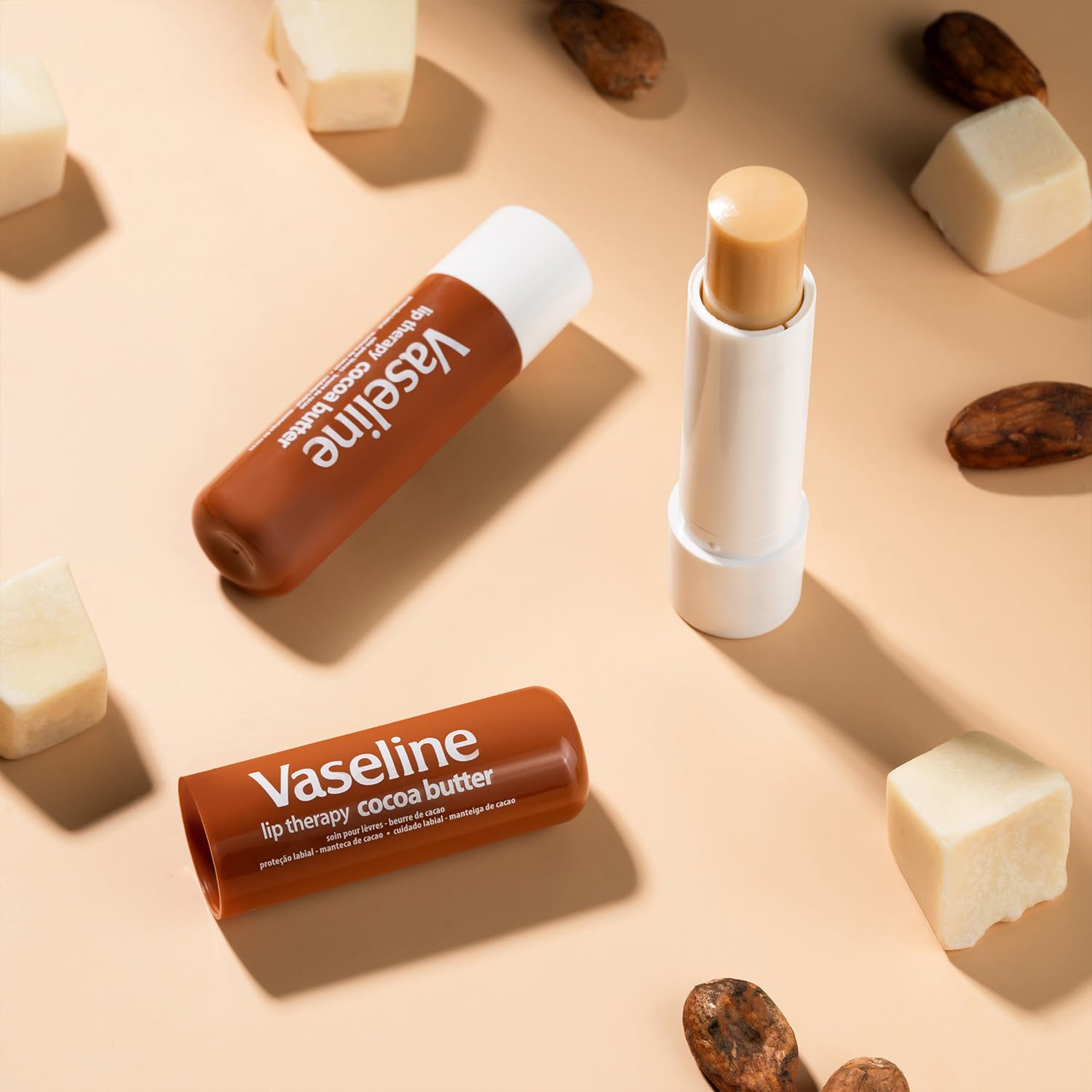Three Vaseline sticks stored in a small travel pouch for easy portability