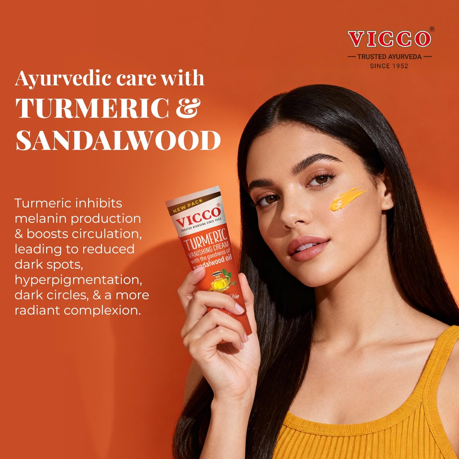 Vicco turmeric root and sandalwood pieces beside tube illustrating natural ingredients