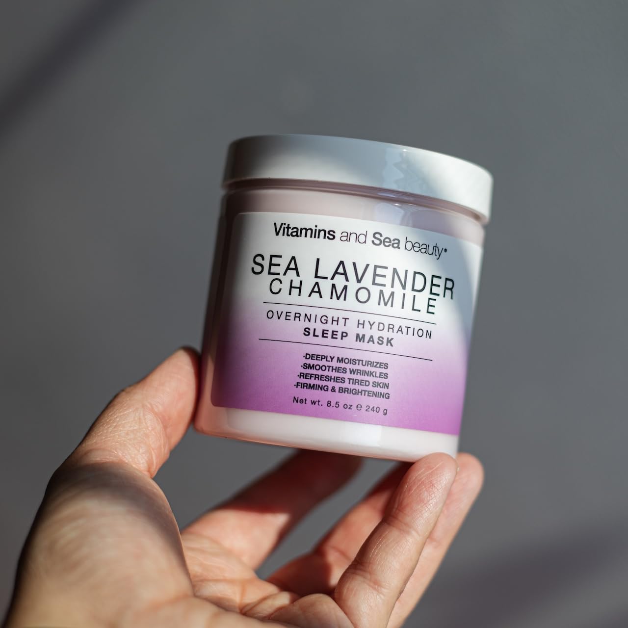 VITAMINS AND SEA BEAUTY jar held in hand to show size and travel-friendly convenience