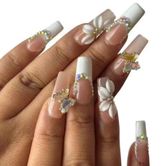 Vlazryk close-up of long square white French tips highlighting classic style
