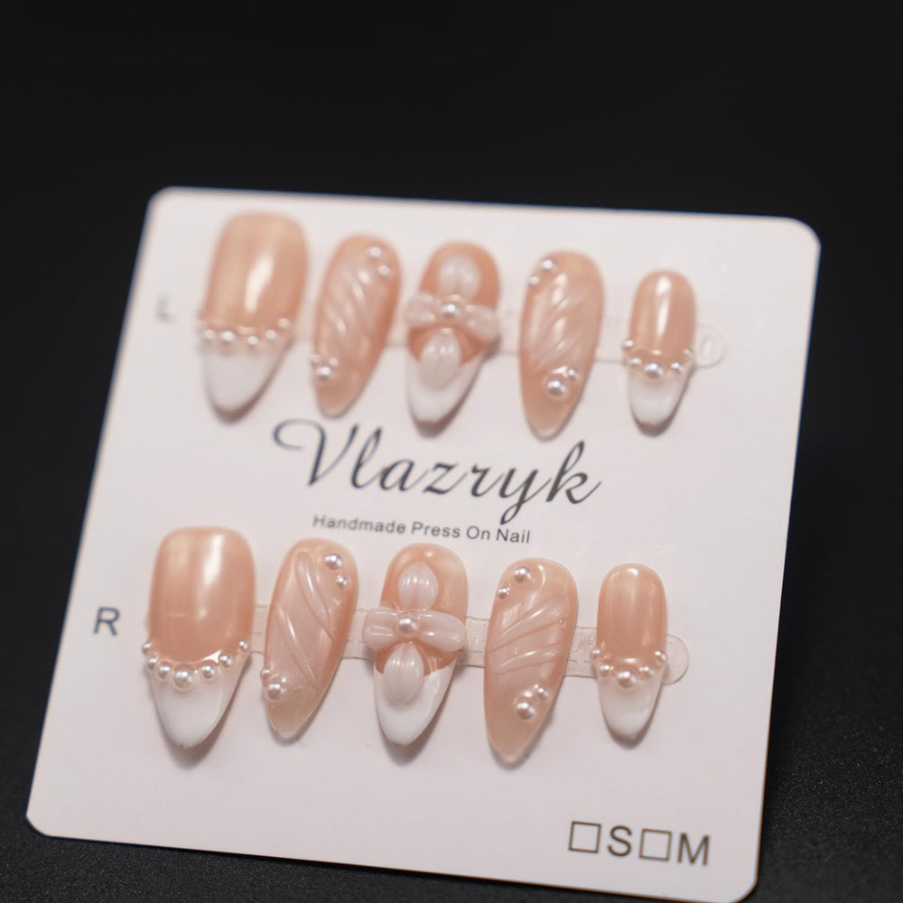 Vlazryk nails on hand for scale to show true size fit