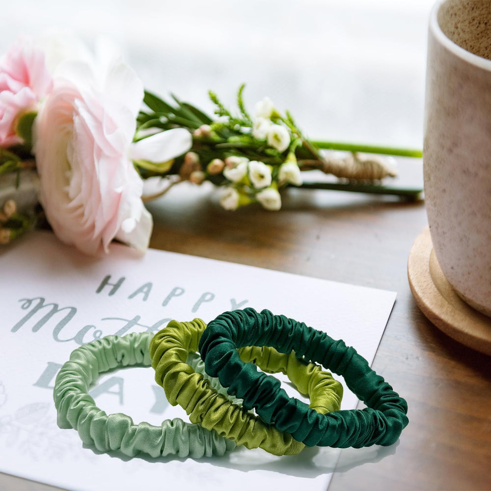 VLOMOT scrunchie beside coin to show slim size and discreet, lightweight benefit