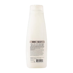 VO5 bottle on bathroom shelf styled with towel and plant, suggests daily tropical routine