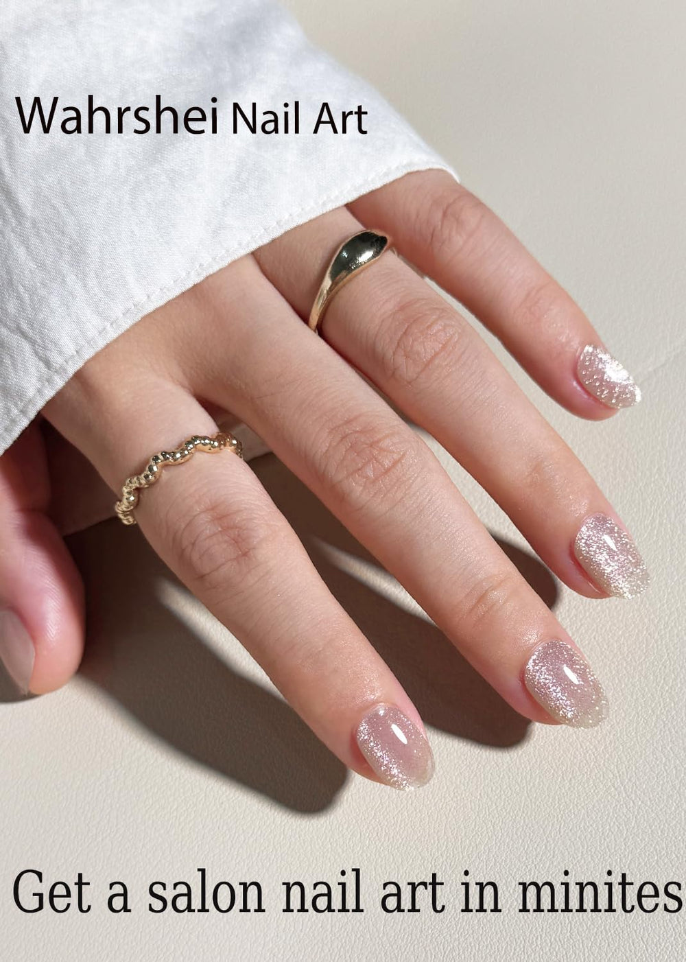 Wahrshei applied on a hand showing finished nude cat eye manicure and salon shine