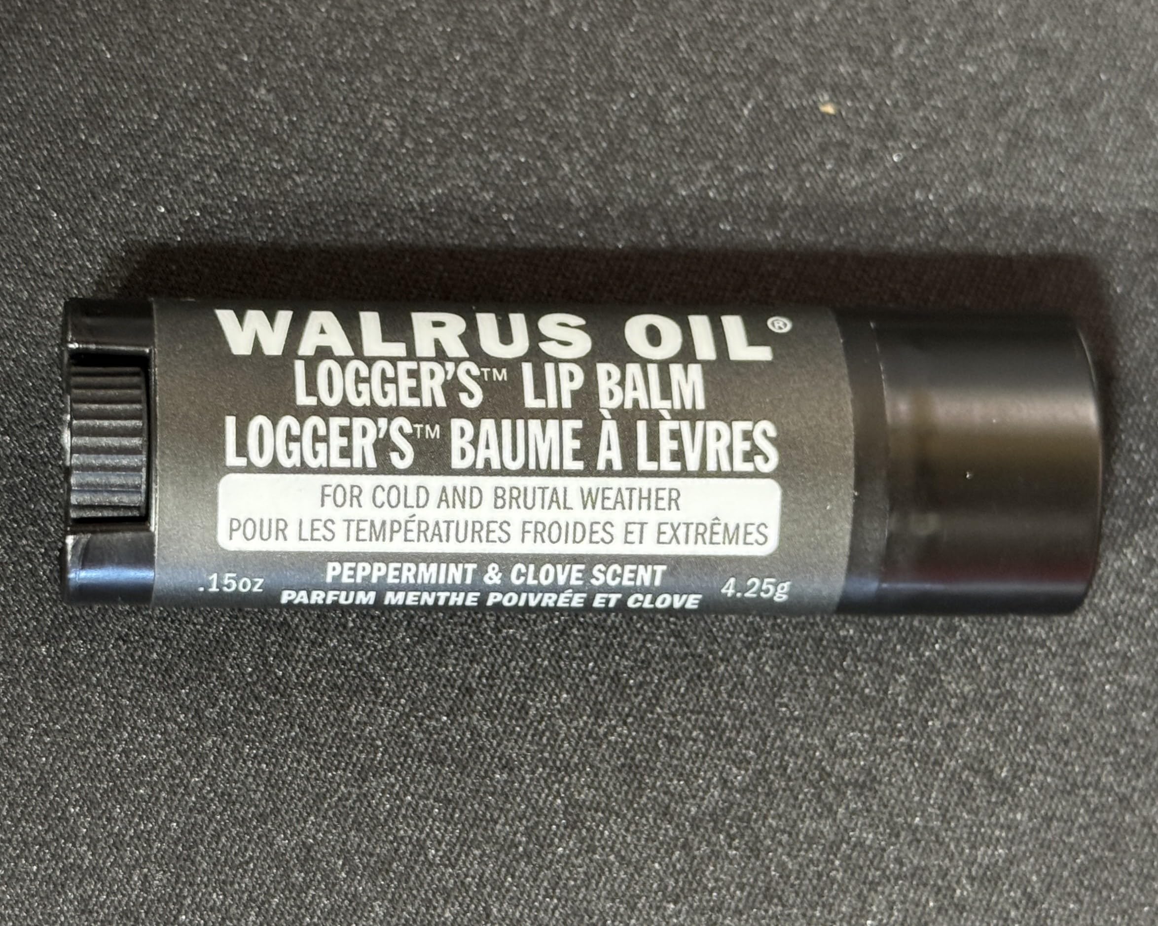Walrus Oil Logger's Lip Balm ingredients arrangement with peppermint and clove showing natural sourcing benefit
