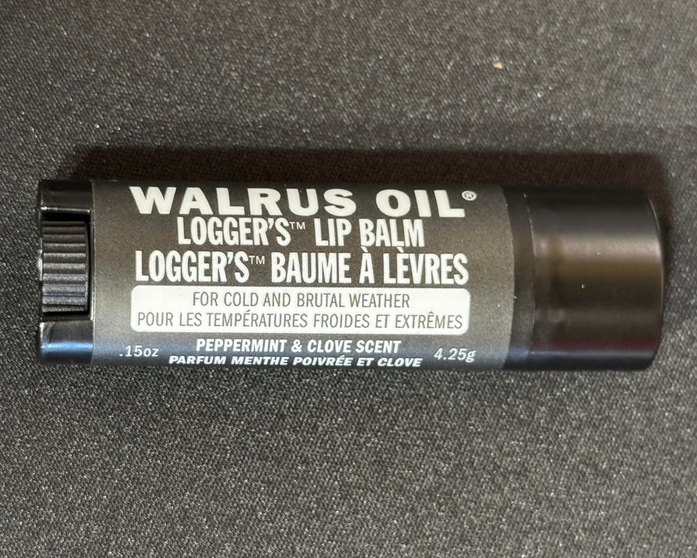Walrus Oil Logger's Lip Balm ingredients arrangement with peppermint and clove showing natural sourcing benefit