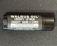 Walrus Oil Logger's Lip Balm ingredients arrangement with peppermint and clove showing natural sourcing benefit