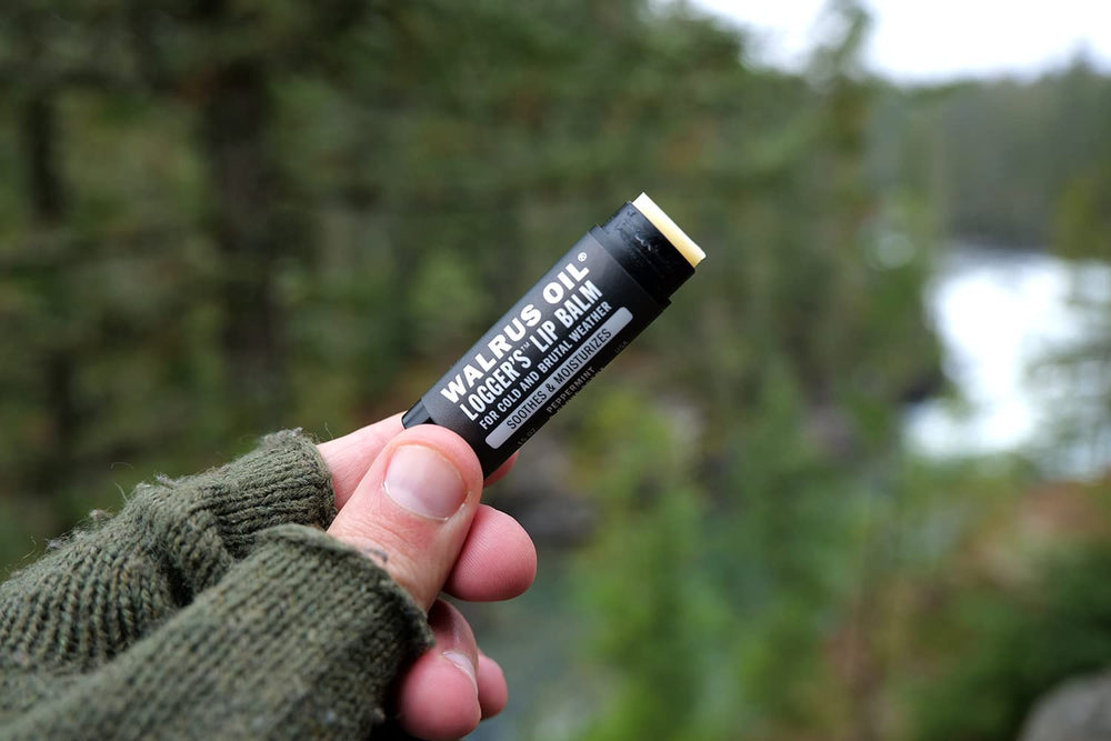 Walrus Oil Logger's Lip Balm in outdoor setting on a jacket showing durability for outdoor use benefit