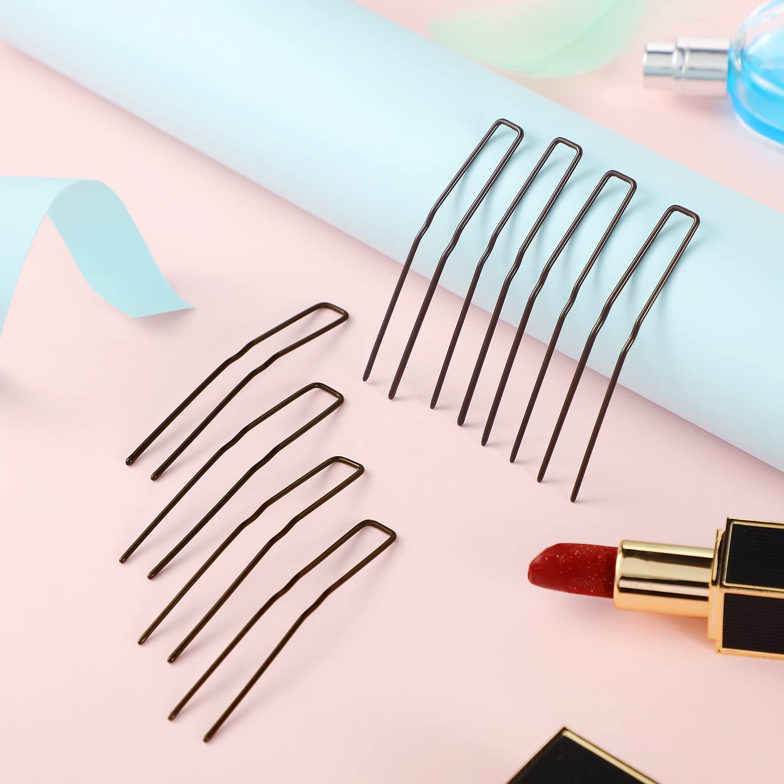 Waydress pins held in hand to show 3-inch scale and practical sizing benefit