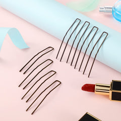 Waydress pins held in hand to show 3-inch scale and practical sizing benefit