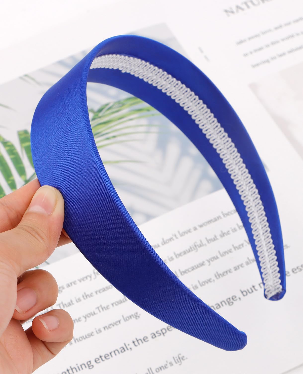 Wecoe royal blue headband in a styled flatlay with outfit pieces showing holiday-ready versatility