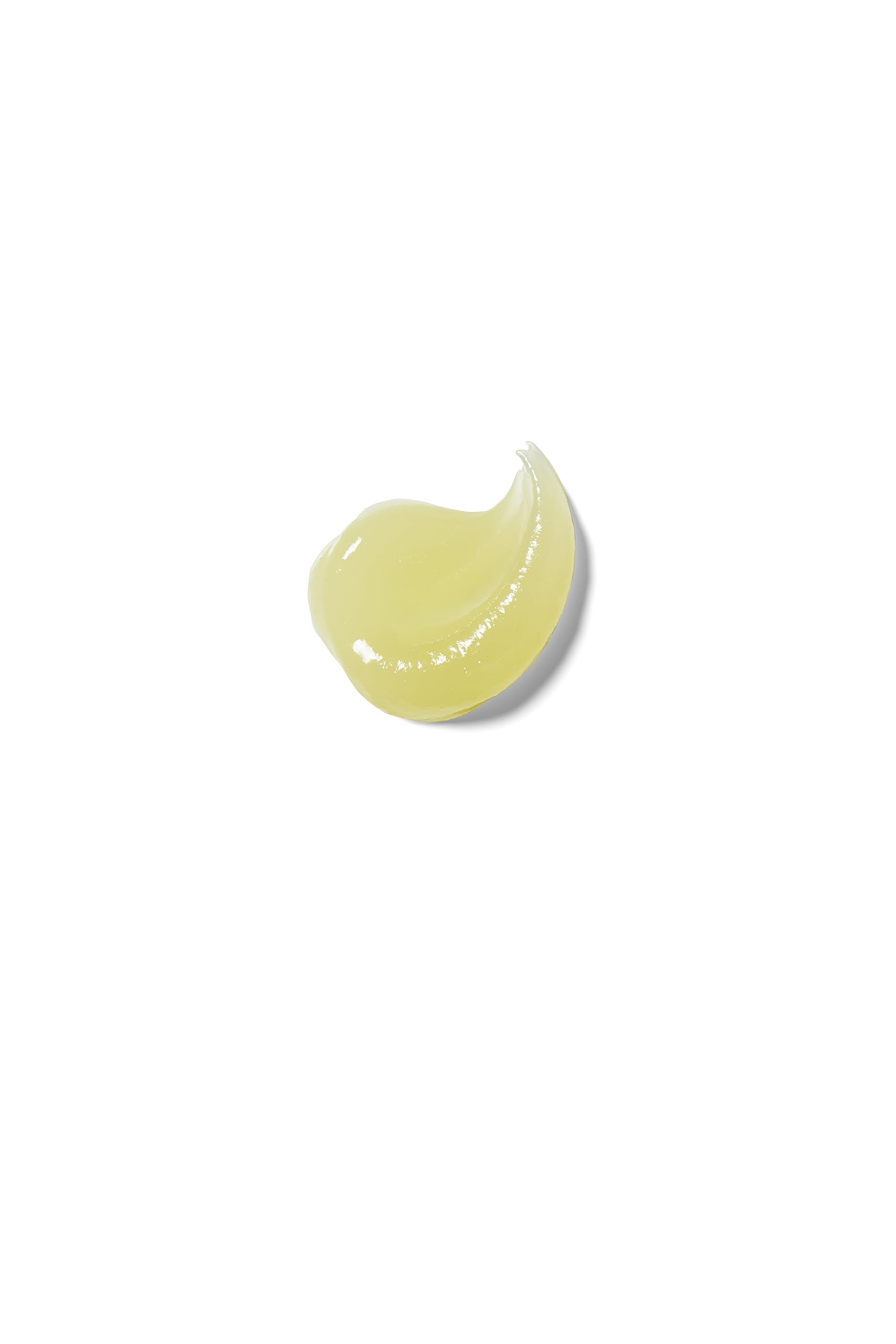 Weleda lip butter next to a coin to show small size and easy portability