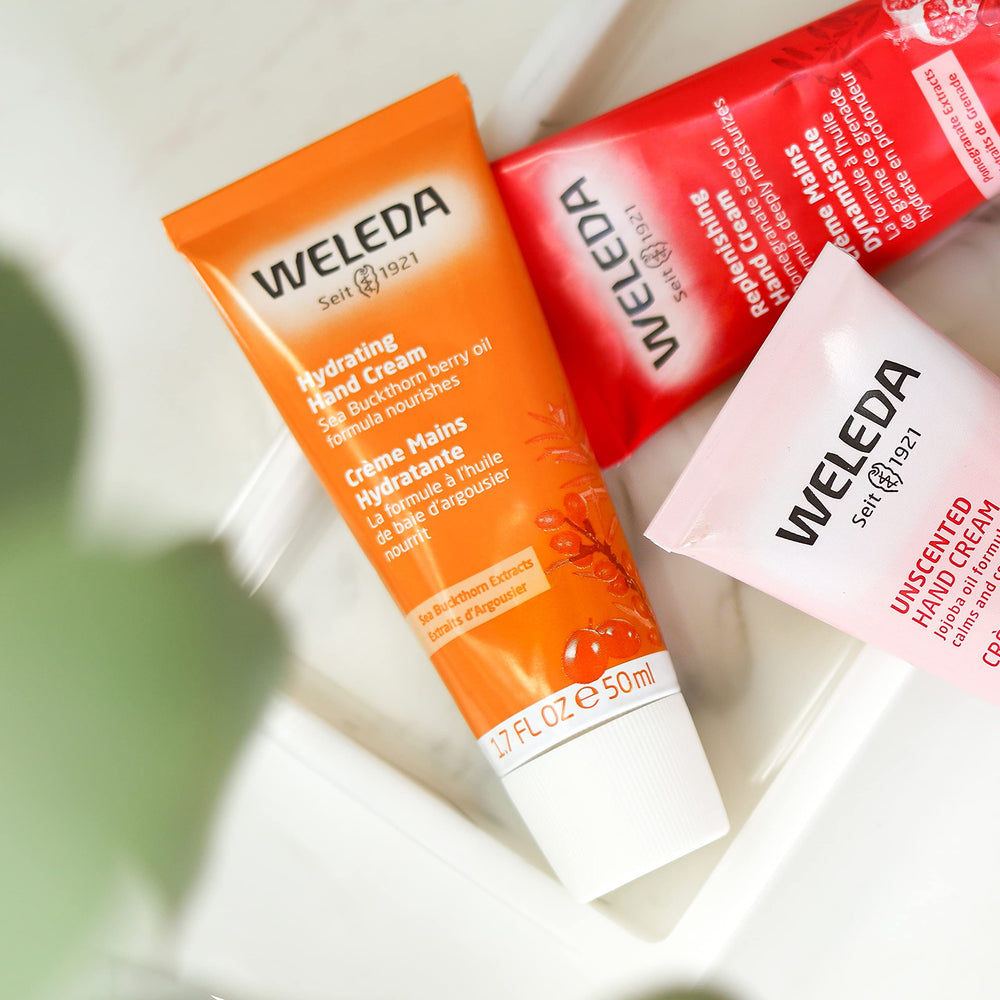 Weleda sea buckthorn hand cream applied to hands illustrating softening and protective barrier benefits