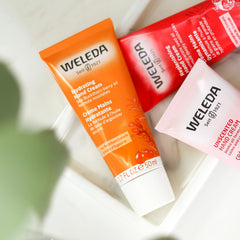 Weleda sea buckthorn hand cream applied to hands illustrating softening and protective barrier benefits