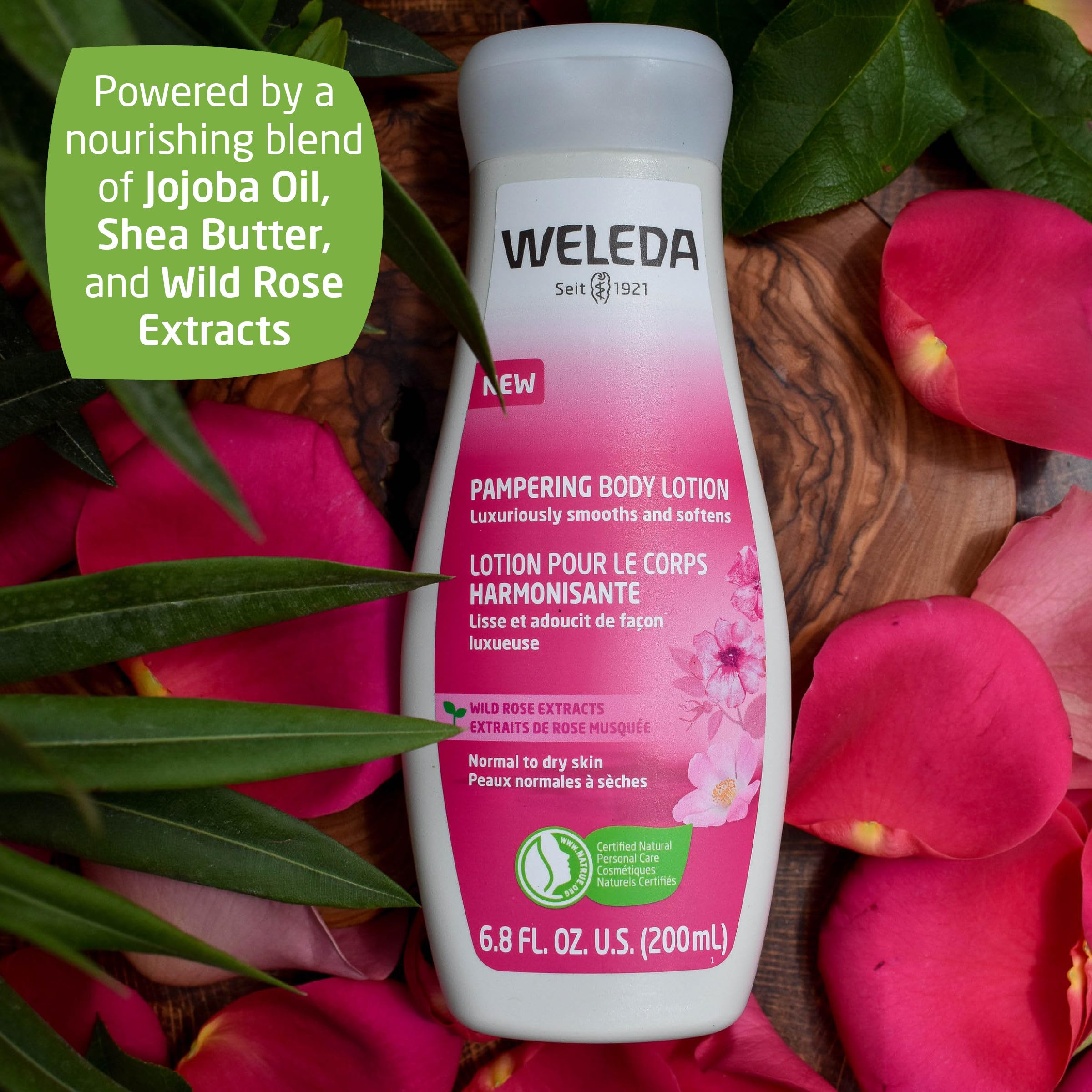 Weleda wild rose bottle in hand for scale and travel-friendly benefit