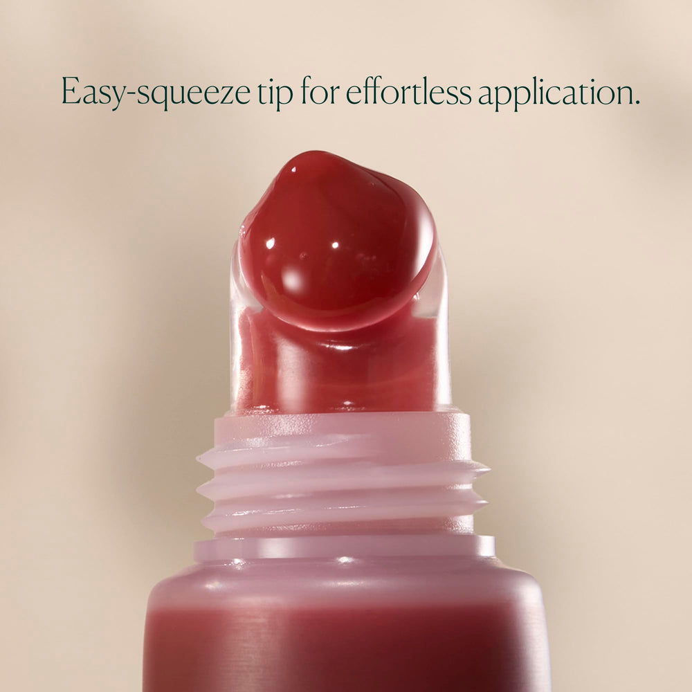 Well People on lips lifestyle shot, showing sheer pink grapefruit color and plumper look