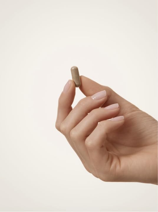 hand holding WELLBEL bottle showing product size and convenient serving