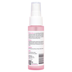 Well's Oil bottle beside fresh roses emphasizing natural hydrosol