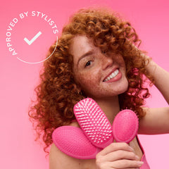 Wet Brush size comparison next to a hand showing portable scale and travel-ready convenience