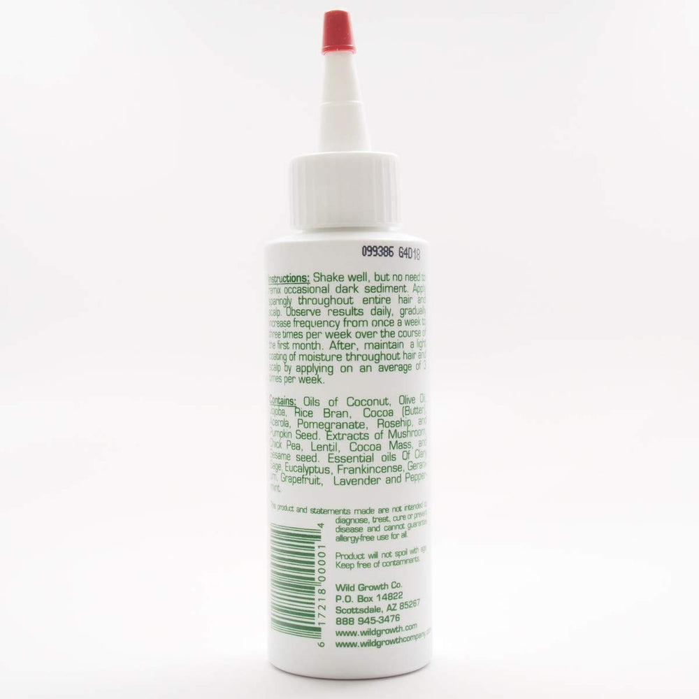 Wild Growth oil texture close-up on fingers demonstrating smooth conditioning benefit