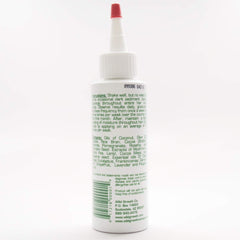 Wild Growth oil texture close-up on fingers demonstrating smooth conditioning benefit