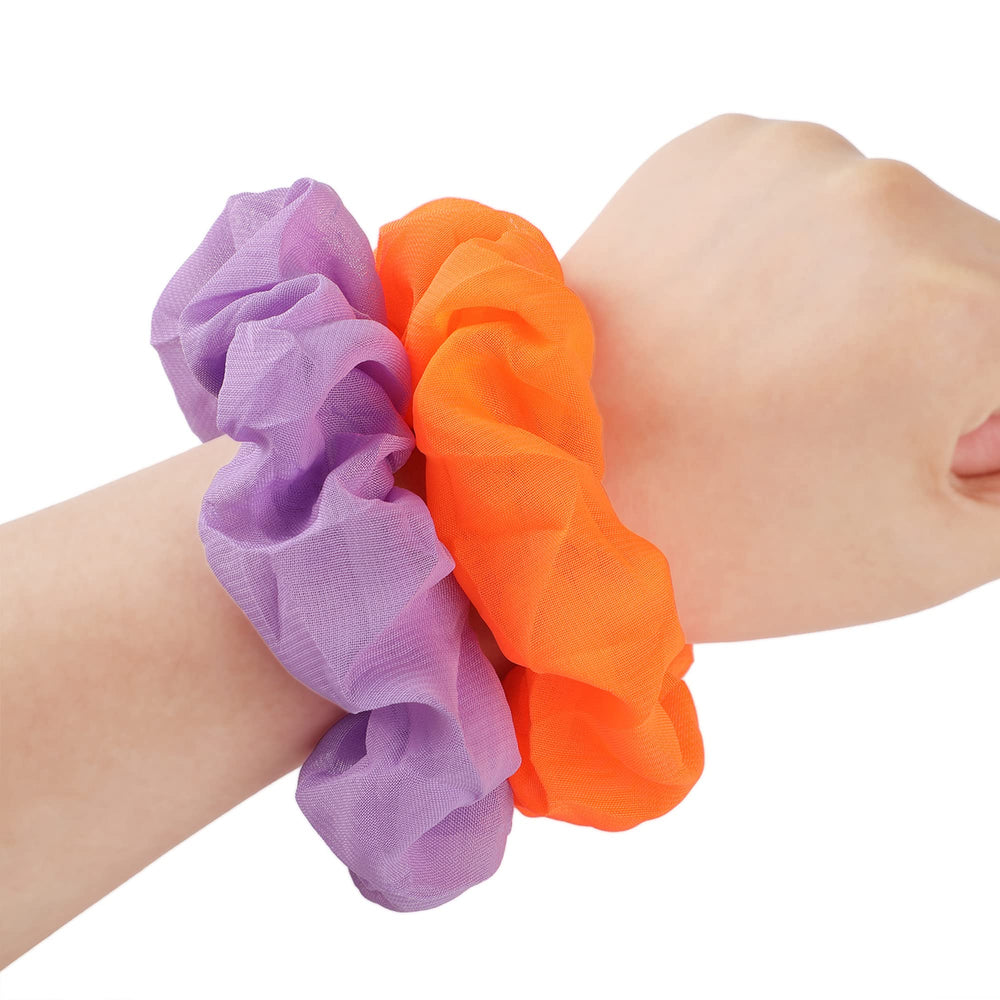 WILLBOND scrunchie next to a hand for size comparison showing stretchability benefit