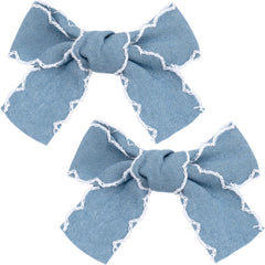Winsyison front view of two light blue denim bow clips showing vintage lace edges and pretty finish