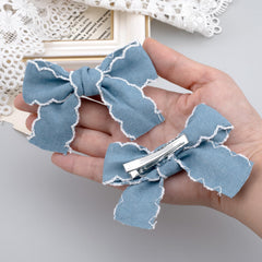 Winsyison metal clip mechanism visible under bow showing secure non-slip hold for thicker hair