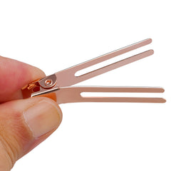 Wobe clip in use securing a pin curl for faster, reliable salon results