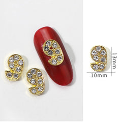 WOKOTO charms beside a coin for scale to show tiny size and precise placement