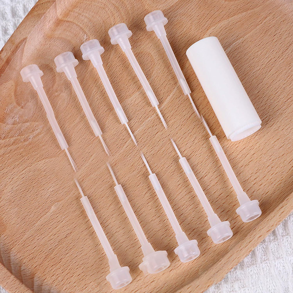 WOKOTO brushes beside hand for size comparison, illustrating compact portability