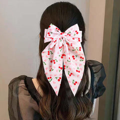 WRBAJIS cherry bow size scale on hand demonstrates large, statement dimensions