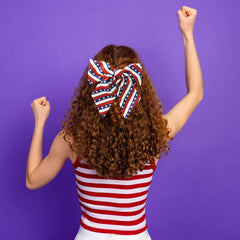 WUIIOE bow clipped into adult ponytail showing visible patriotic accent