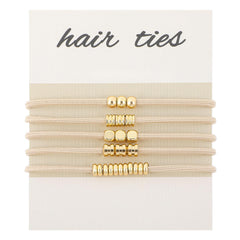 WY LIGHTING LEVEL front view of five gold-beaded hair ties showing elegant styling benefit