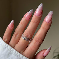 XCREANDO hand applying a press-on nail for quick at-home manicure convenience