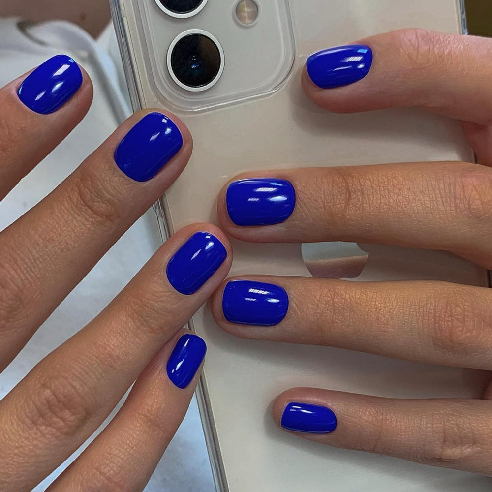 XCREANDO close-up of a single royal blue short square nail highlighting smooth gel finish