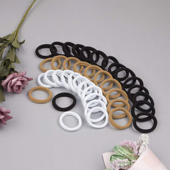XIMA pack of hair ties inside a gym bag showing travel-friendly convenience