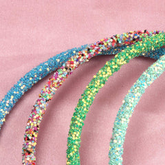XIMA headband on hand for size comparison showing compact, travel-ready benefit